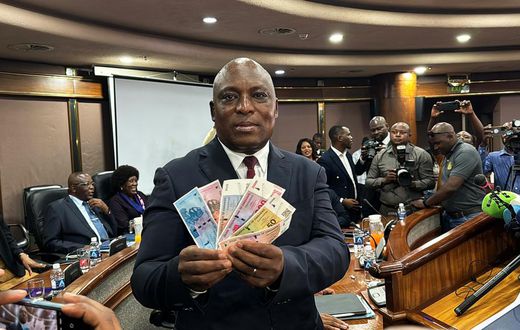 John Mushayavanhu, Governor of the Reserve Bank of Zimbabwe, presents the new national currency Zimbabwe Gold, or ZiG.Columbus Mavhunga/picture alliance/Getty Images