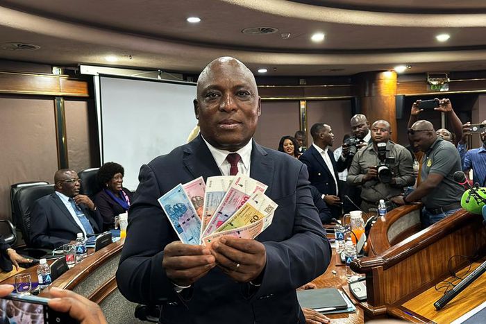 John Mushayavanhu, Governor of the Reserve Bank of Zimbabwe, presents the new national currency Zimbabwe Gold, or ZiG.Columbus Mavhunga/picture alliance/Getty Images