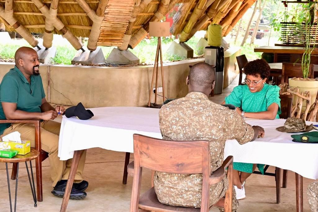 Gen. Kainerugaba (L) in conversation with UTB CEO Lilly Ajarova (green dress) and another official