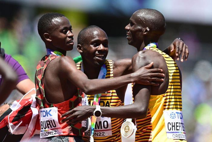EUGENE, OREGON - JULY 17: Gold medalist Joshua Cheptegei of Team Uganda, silver medalist Stanley Waithaka Mburu of Team Kenya and bronze medalist Jacob Kiplimo of Team Uganda celebrate after the Men's 10,000m Final on day three of the World Athletics C...