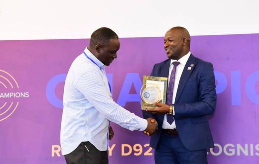 Next Media Group CEO Kin Kariisa (left) receiving the accolade at the 99th District 9214 Rotary Leadership Conference held in Munyonyo.