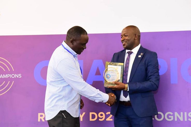 Next Media Group CEO Kin Kariisa (left) receiving the accolade at the 99th District 9214 Rotary Leadership Conference held in Munyonyo.