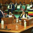 Wilson Kajwengye (L) speaking during the Committee of the Whole House on Tuesday, April 23. Speaker, Anita Among (C) and a staff of Parliament (R) are at the Clerk’s Table