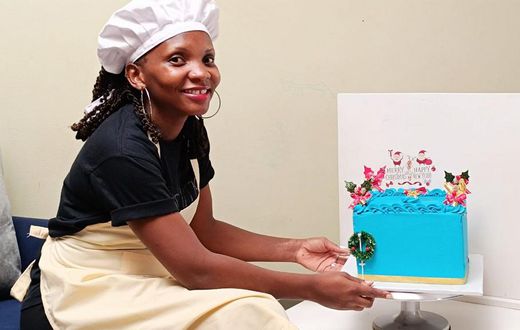 Mary Nankinga Kawuki showing off a cake she made