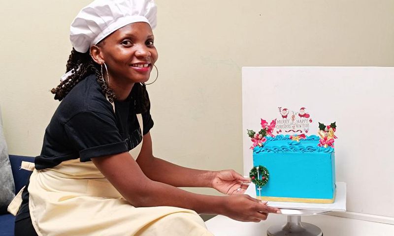 Mary Nankinga Kawuki showing off a cake she made