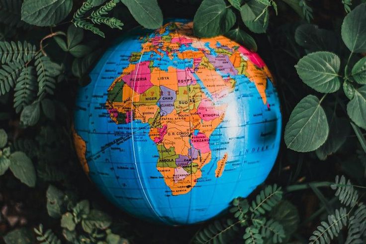 Globe in green leaves with map of Africa in view [Photo: Nothing Ahead]
