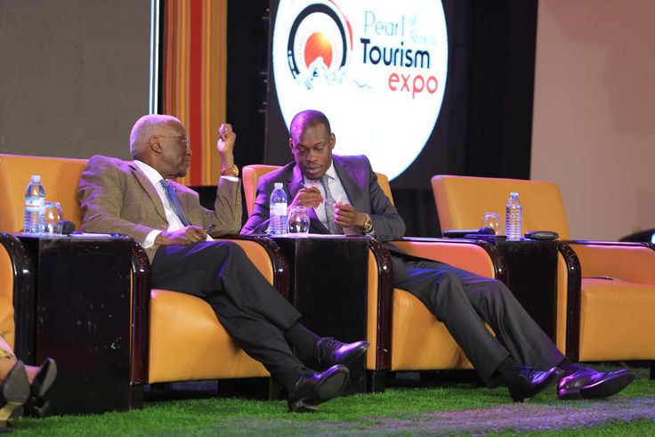 Tourism Minister Tom Butime (L) and his Junior Martin Mugarra Bahinduka at the Pearl of Africa Tourism Expo on Wednesday