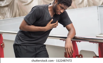 A stock photo of someone posing like they suffered a heart attack