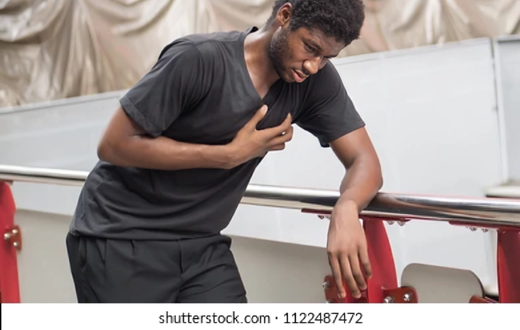 A stock photo of someone posing like they suffered a heart attack