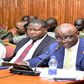 Ssempijja (R) appearing before the Committee on Defence and Internal Affairs. On his right are State Ministers Oboth Oboth and Huda Oleru.