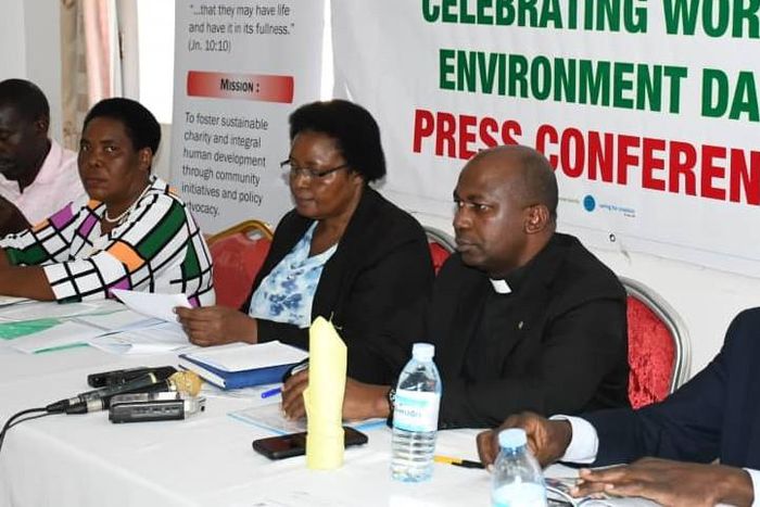 Fr. Hilary Muheezangango, the Caritas National Director (R) addressing press on Thursday ahead of the World Environment Day