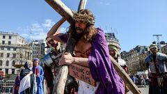 Actor James Burke-Dunsmore carries the crucifix whilst playing Jesus during The Wintershall's 'The Passion of Jesus' in front of crowds on Good Friday.Chris Ratcliffe/Getty Images