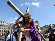 Actor James Burke-Dunsmore carries the crucifix whilst playing Jesus during The Wintershall's 'The Passion of Jesus' in front of crowds on Good Friday.Chris Ratcliffe/Getty Images