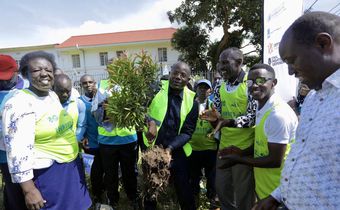 Kyakulya (centre) planting a tree to mark Human Rights Defenders Day. Photos by Ambrose Watanda