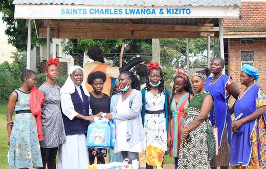 Sister Mary Lunyoro of Mbale Babies home receiving donations from Sheila Muwala Mulungi's Foundation