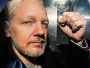WikiLeaks founder Julian Assange gestures from the window of a prison van as he was driven into Southwark Crown Court in London in May 2019.DANIEL LEAL/AFP via Getty Images