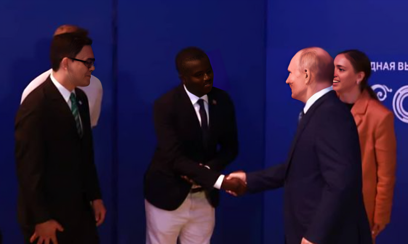 Davis Akampulira shakes hands with Russian President Vladimir Putin