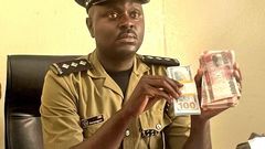 Luke Owoyesigire showing some of the counterfeit money seized in the police operation