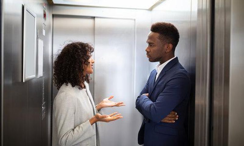 Black couple inside an elevator [Adobe Stock]