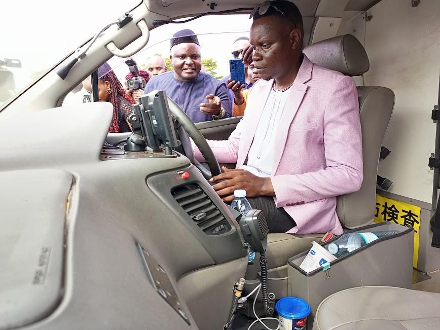 Butebo RDC Paul Mwidu Kilikwani having a test ride of the ambulance