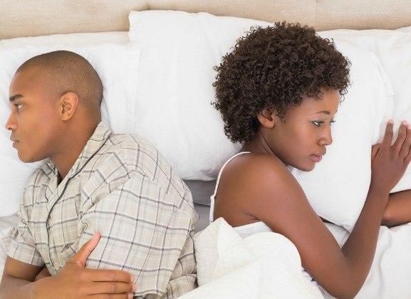 Estranged couple in bed