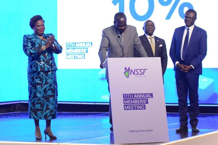 Minister Betty Amongi (L) watches as colleague Matia Kasaija announces the NSSF interest rate