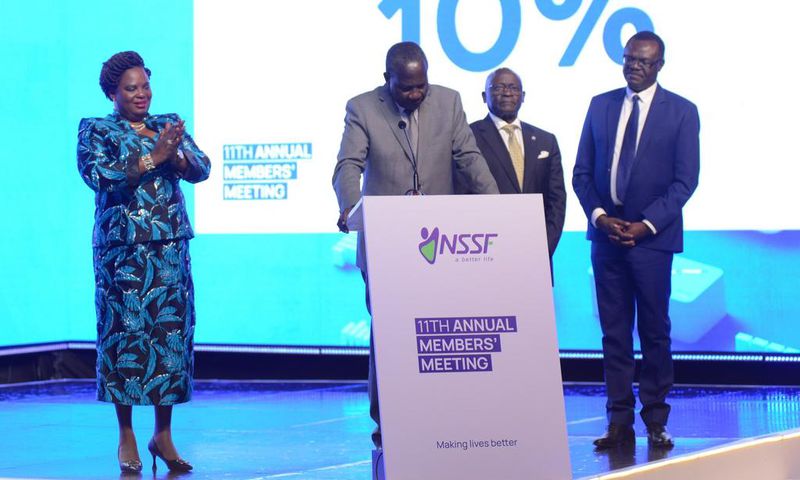 Minister Betty Amongi (L) watches as colleague Matia Kasaija announces the NSSF interest rate
