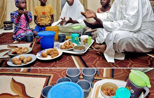 A father and his family sit around a meal for Iftar during Ramathan