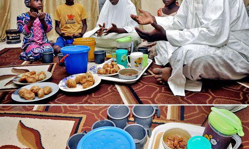 A father and his family sit around a meal for Iftar during Ramathan