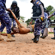 Police detain a protestor in Luuka
