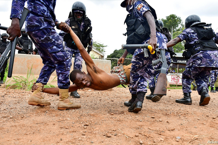 Police detain a protestor in Luuka