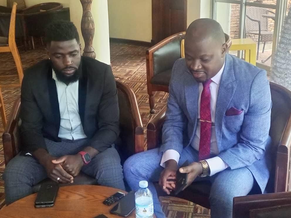Stuart Raymond Kasule and Andrew Kyamagero addressing press about the campaign