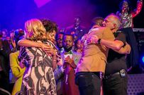 The Skinners hug the new Church leaders after being commissioned