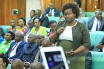Faith Nakut the MP for Napak district speaking on the house floor. Women MPs are expected to wear suits, dresses (with or without jackets), blouses with skirts, or appropriate traditional wear.