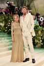 Elsa Pataky and Chris Hemsworth coordinated in tan and gold.
