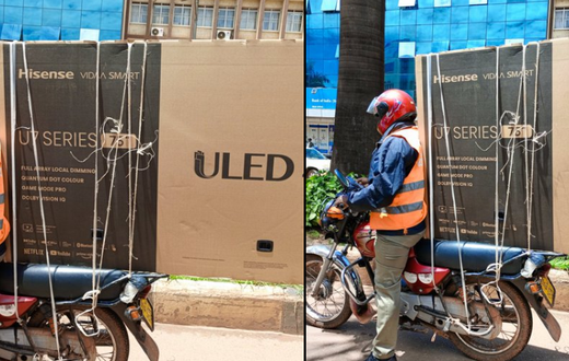 Boda boda rider securing television screen on bike/Courtesy