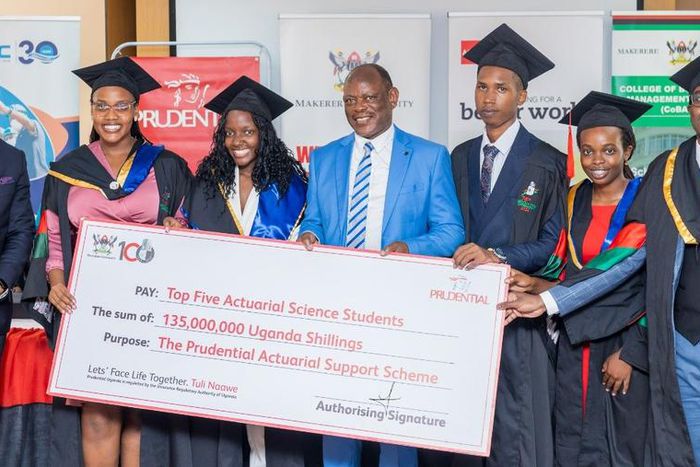 VC Prof Barnabas Nawangwe and Tetteh Ayitevie, the CEO Prudential Assurance Uganda posing with the 2nd cohort graduates