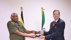 Maj. Gen. Jack Bakasumba receives a souvenir from Ambassador Kumah Gupta
