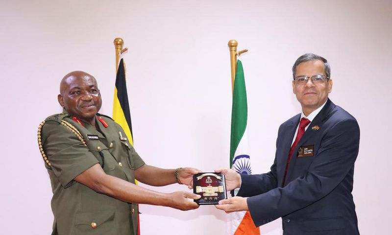 Maj. Gen. Jack Bakasumba receives a souvenir from Ambassador Kumah Gupta