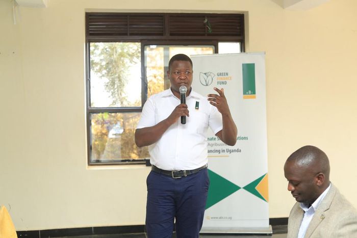 Noah Owomugisha, the aBi Head of Investments—Green Growth and Business Development Services speaking to staff from financial institutions
