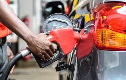 Attendant putting fuel in a car