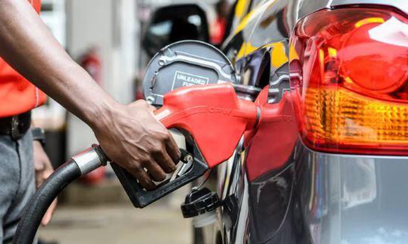 Attendant putting fuel in a car