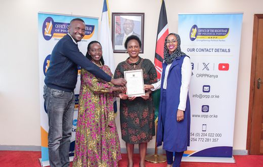 Martha Karua  receiving a change of name certificate from the  Registrar of Political Parties, Anne Nderitu.
