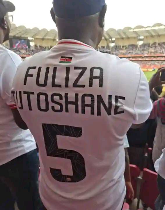 A fan wearing a funny labelled T-shirt