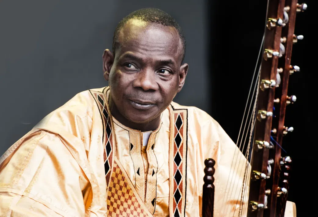Musician Toumani Diabaté of Mali and his 21-string kora, photographed at WOMAD -- the World of Music, Arts and Dance festival held yearly in the United Kingdom.