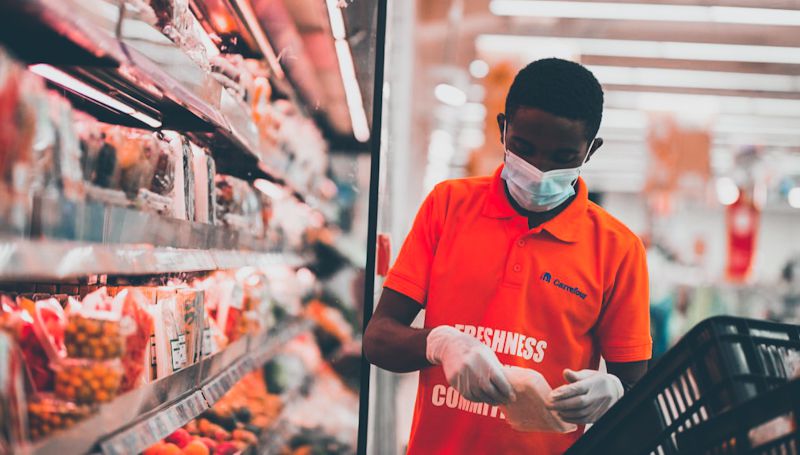 A member of staff working at a Carrefour store
