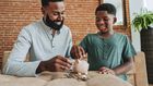 A father and son saving in a piggy bank