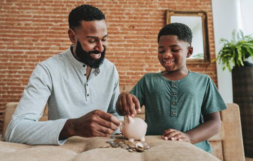 A father and son saving in a piggy bank
