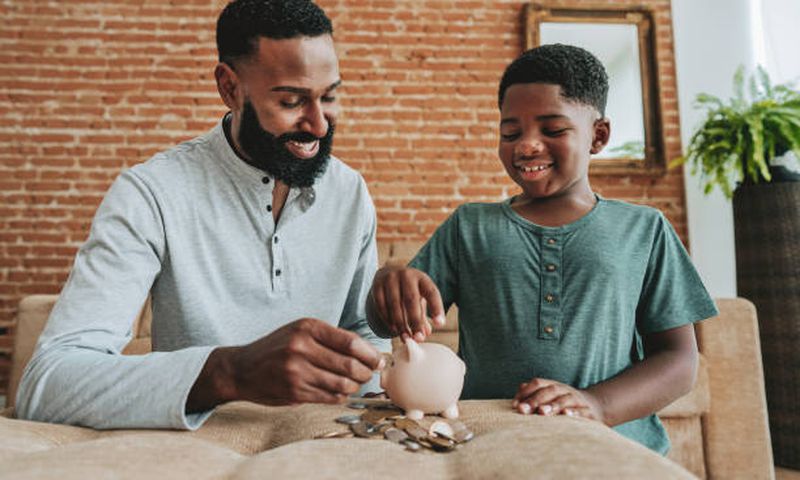 A father and son saving in a piggy bank