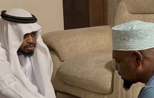 Diamond Platnumz shakes hands with a representative of the Othman family after dowry payment was accepted